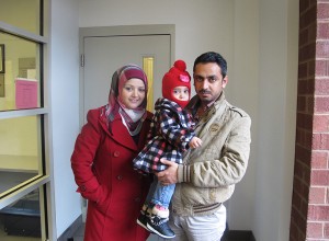 New refugees from Iraq (left to right) Mazyad Noor, daughter Maryann, Abdulrahmam Marwan prepare to to go to the Squirrel Hill Health Center for their first physical. Photo: Erika Beras.