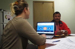 Birkha Tamang, a Bhutanese refugee, hopes to find an affordable health care plan. Assisting him is health navigator Leslie Bachurski of the Consumer Health Coalition.   Photo: Erika Beras