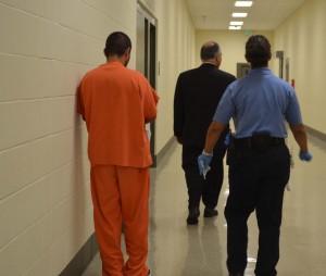 A guard walks a detainee through one of the the hallways in the west wing in Adelanto. Photo: Alonso Yáñez/La Opinión.