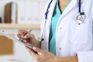 Female medicine doctor hand holding silver pen