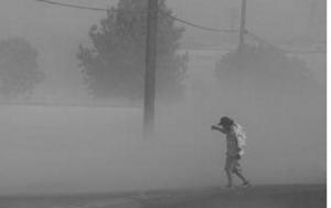 CRAIG KOHLRUSS/THE FRESNO BEE  Dust storms, like this one in Fresno, can help distribute the fungal spores that cause valley fever.