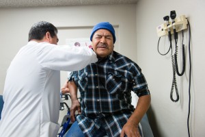 Luis Bautista, an internist at Bautista Medical Center in Fresno, Calif., examines farm worker Jose Gonzalez on February 8, 2017. Gonzalez says he is not ready to retire and needs his insurance to stay healthy. (Heidi de Marco/KHN)