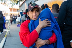 José Manuel Salinas, de Acapulco, México, sostiene al bebé de su amigo mientras espera que lo vea una enfermera. Salinas dice que le tomó cerca de un mes caminar y hacer varias paradas para llegar a la ciudad fronteriza de Tijuana, BC. Él había estado luchando contra un resfriado durante aproximadamente dos semanas, dice.