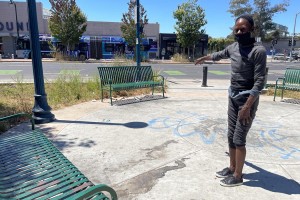 Hunter slept on an Oakland bench for nearly a year before moving a few feet away into a bright-red tent. When she slept on the bench, rats crawled over her at night and her belongings were sometimes stolen. She feels much safer in her tent, she says. (Angela Hart / California Healthline)