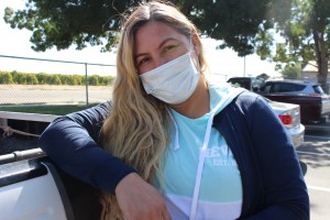 La trabajadora agrícola Alejandra Beltrán, de 44 años, se apoya en su camioneta pick-up cerca de los viñedos en Biola, California, el 13 de octubre de 2021. Beltrán dijo que trabajó al aire libre en condiciones de mucho humo tan recientemente como el 4 y 5 de Octubre, pero no estaba al tanto de las protecciones requeridas para los trabajadores. Foto: Farida Jhabvala Romero/KQED.