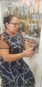 Martha Aguilar, vendedora ambulante, trata de ver su solicitud con su teléfono celular. Foto: Cortesía.